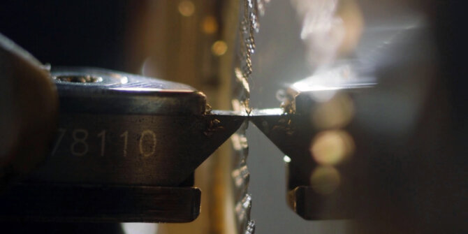 Macro of a metal tool working a part, sparks and bokeh – DS Savoir-faire in Motion