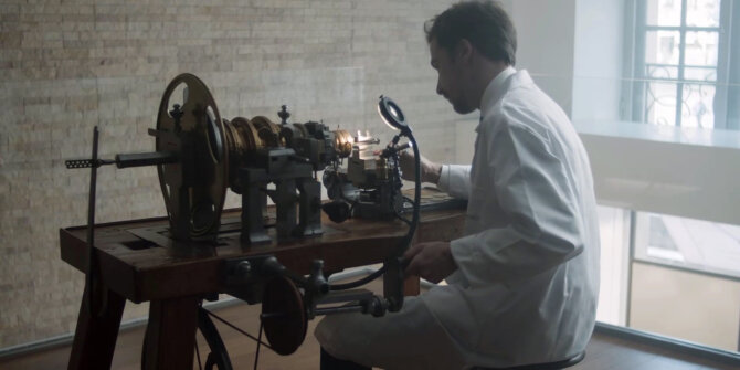 Craftsman in a white coat working at an antique guilloché lathe – DS Savoir-faire in Motion