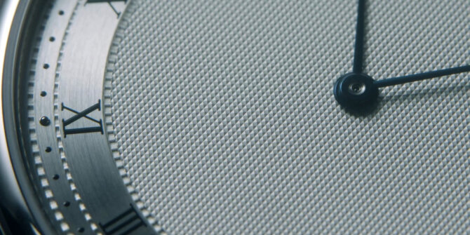 Macro of a watch dial with Roman numerals and guilloché texture – DS Savoir-faire in Motion