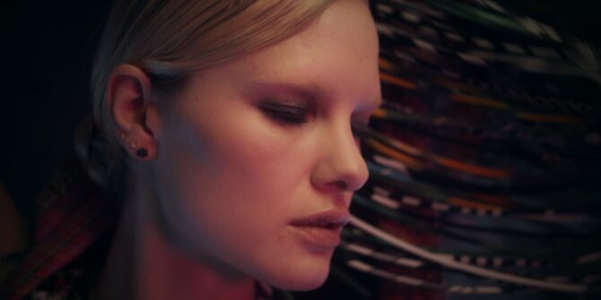 Profile of a blonde model with eyes lowered before coloured fringes – Ginette NY Ajna