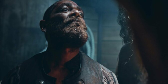 Bearded pirate looking up in a dark ship's hold, low-angle shot – La Buse, the Pirates' Cursed Gold