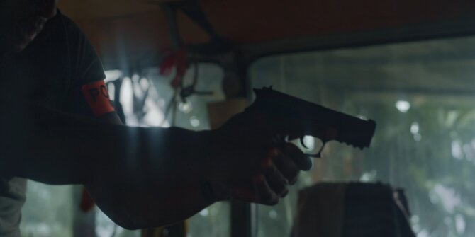 Arm holding a gun inside a vehicle, backlit – OPJ Season 4 Bianca prime-time episode