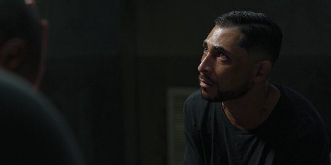 Man looking up in a dark interrogation room, side light – OPJ Season 4 Bianca