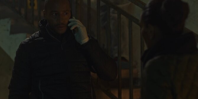 Detective on the phone in gloves at the foot of a dark staircase – OPJ Season 5 Double Lady