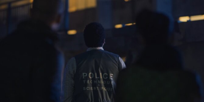 Forensic officer in a “Police technique et scientifique” vest at night – OPJ Season 5
