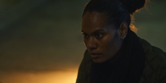 Policewoman with her hair in a bun, face lit by warm side light – OPJ Season 5 Double Lady